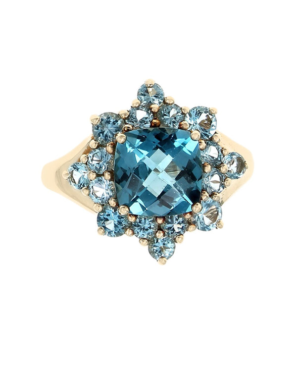 Blue Topaz Halo Ring in Yellow Gold