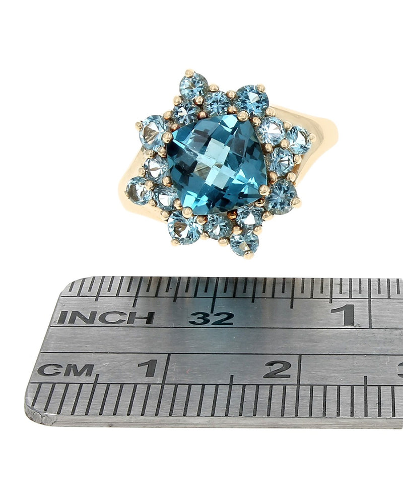 Blue Topaz Halo Ring in Yellow Gold